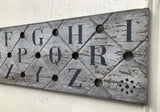 Alphabet on decorative antique board