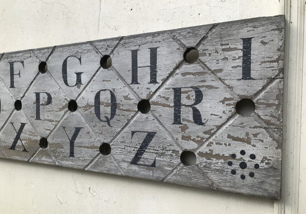Alphabet on decorative antique board